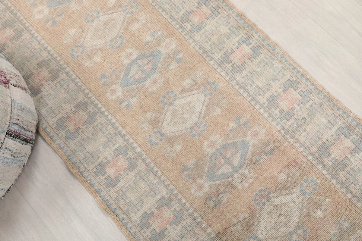 Overhead angle view highlighting the faded tan field and geometric motifs of the runner