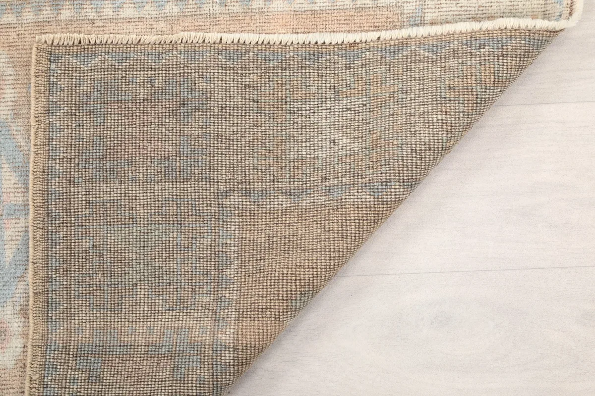 Folded corner view revealing the tightly woven back of the vintage Anatolian runner