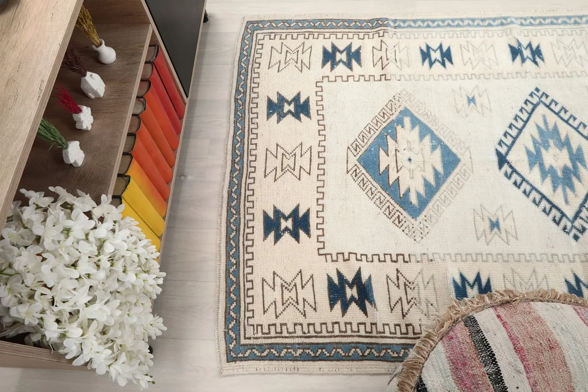 Overhead angle showing part of the rug with surrounding room elements, emphasizing its color palette.