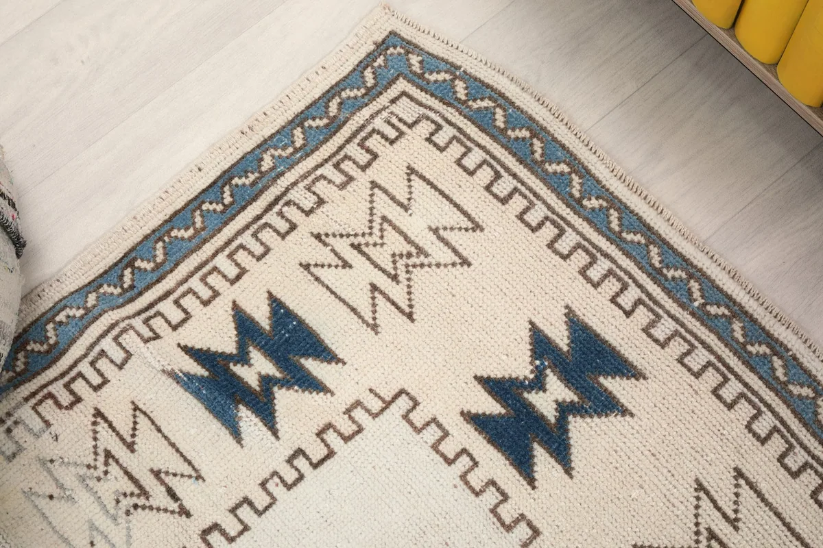 Detailed shot of the rug's outer border, showcasing the intricate blue and navy patterns and edge finishing.