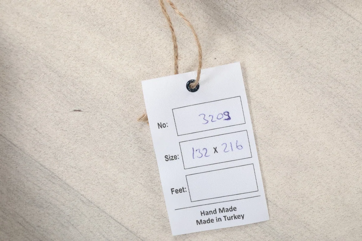 Product tag indicating the rug's size in centimeters and origin as Hand Made in Turkey.
