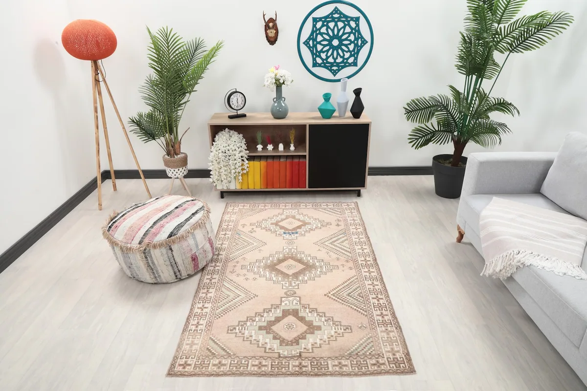Vintage pink geometric tribal rug in a modern living room setting