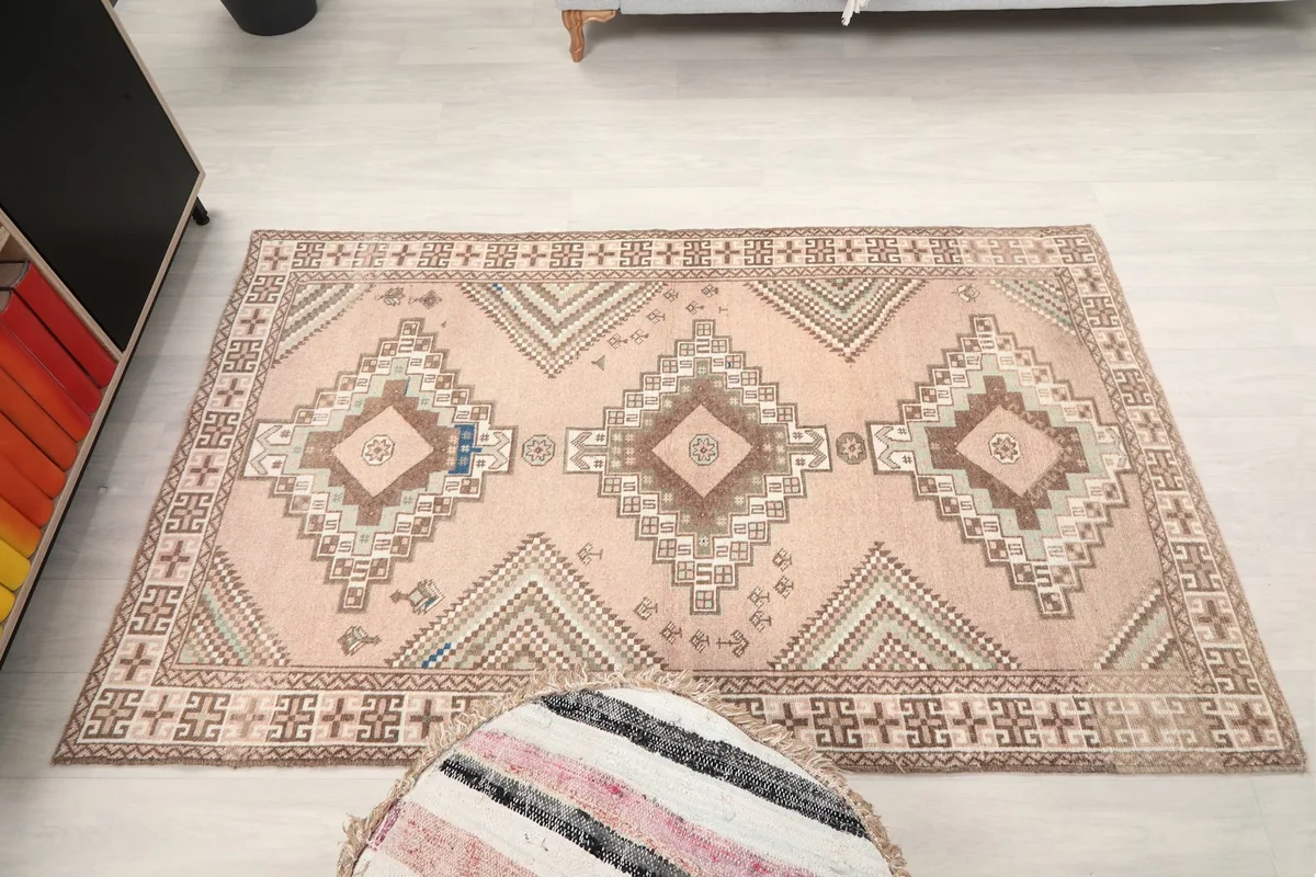 Full overhead view of the pink geometric tribal rug in a room setup