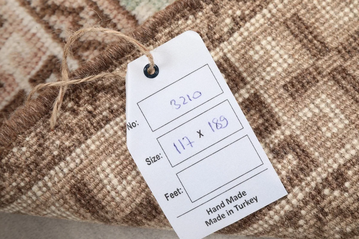 Product tag attached to the rug, showing size in centimeters and origin
