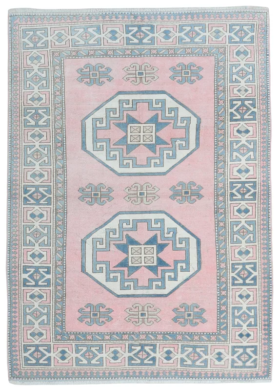 Full top view of a 5'8" x 8'2" vintage Anatolian rug with a pink field and geometric blue and ivory patterns.