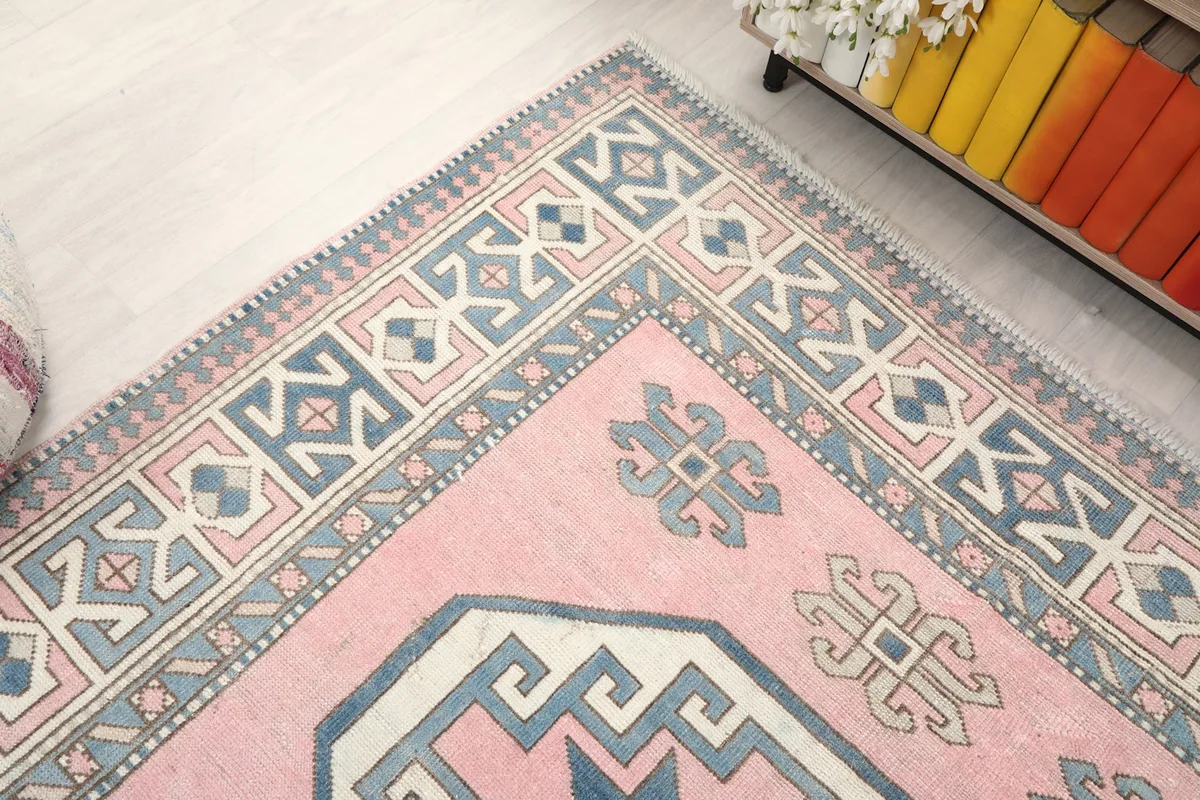 Top-down angle of the rug's upper left corner, emphasizing the border and field patterns.