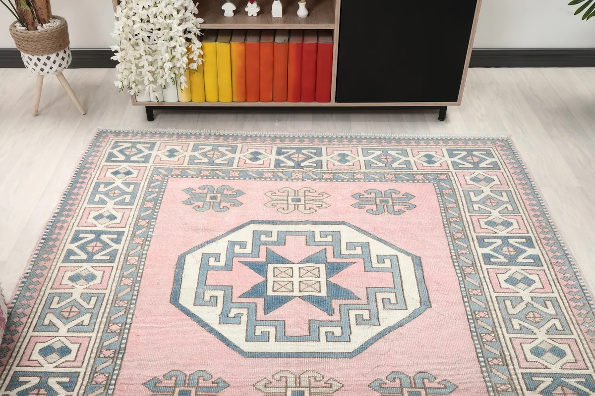 Overhead view of the vintage pink rug in a room, showing its placement relative to furniture.