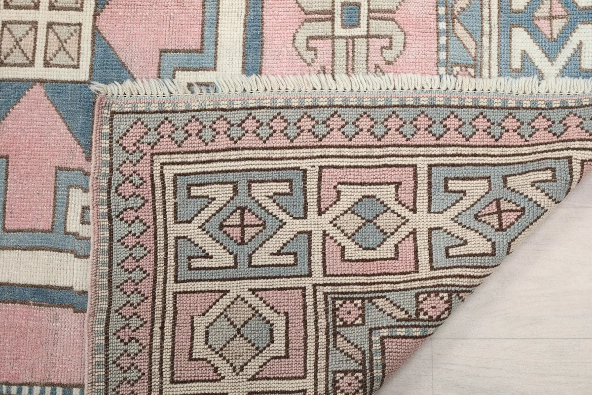 Another view of the back of the rug, showing the reverse side of the border and field patterns.