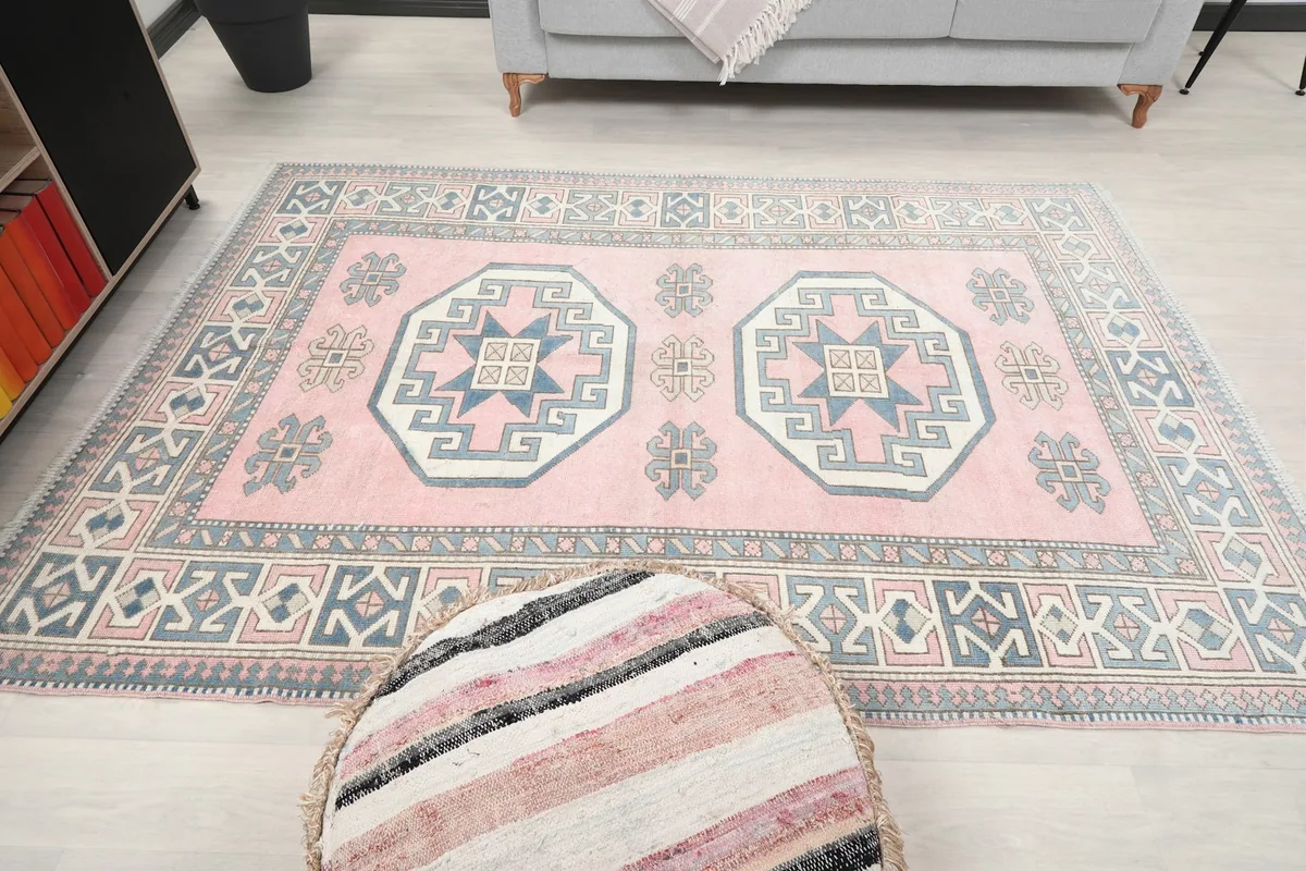 Full overhead view of the vintage rug in a room, showing its overall design and color palette.