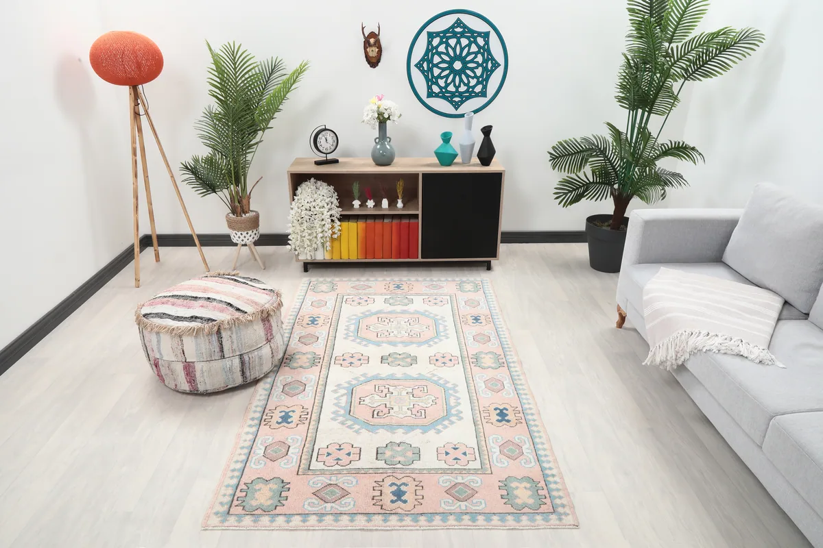 Pink Geometric Anatolian Rug in a living room setting, showcasing its size and colors with furniture.