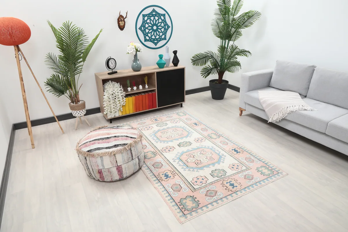 Pink Geometric Anatolian Rug from an elevated angle in a room, highlighting its placement and scale.