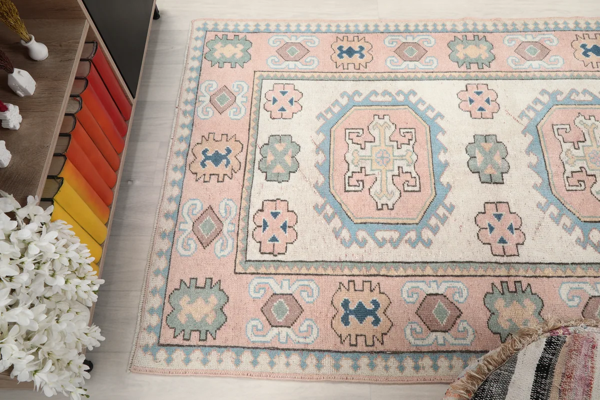 Pink Geometric Anatolian Rug viewed from a high angle, capturing the full pattern and room context.