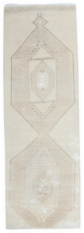 Full overhead view of the beige and tan geometric Anatolian runner on a white background