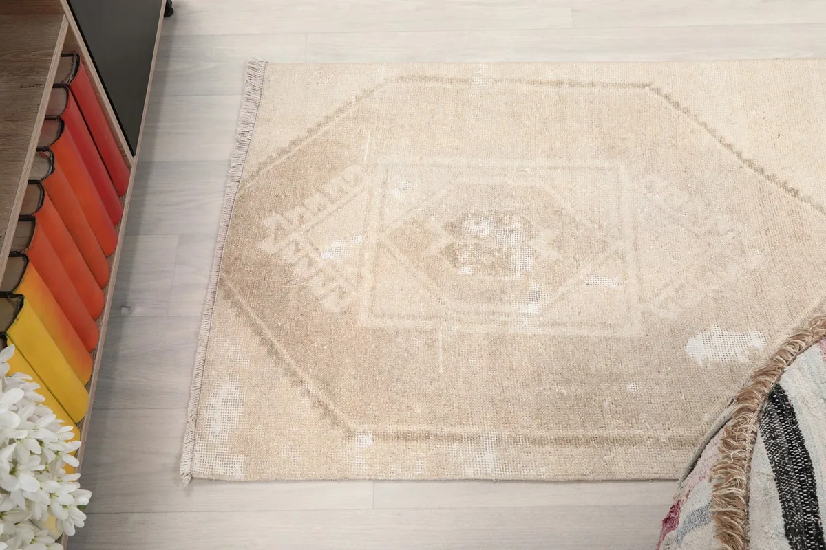 Top-down view of a section of the rug, emphasizing the geometric patterns and field color