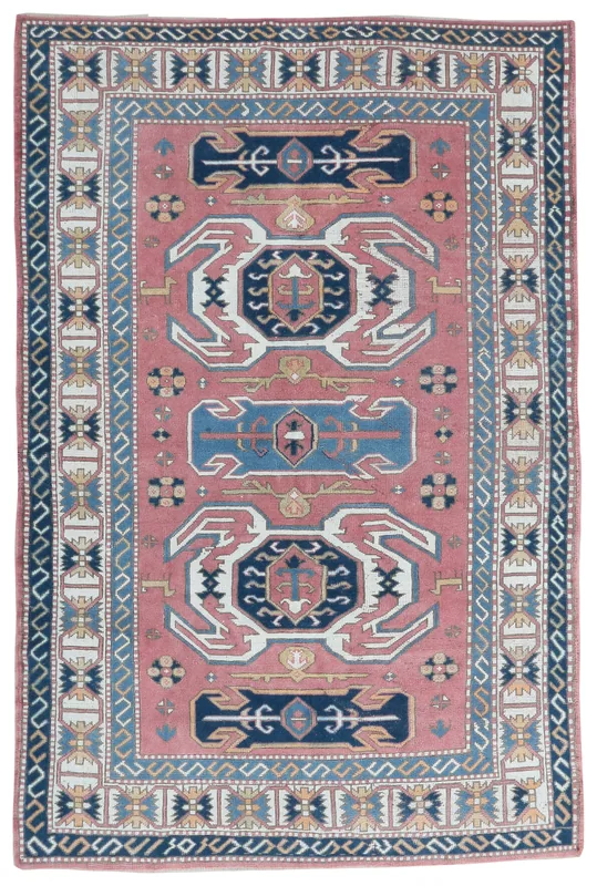 Full overhead view of the 5'7" x 8'8" vintage rose and navy geometric Anatolian wool rug