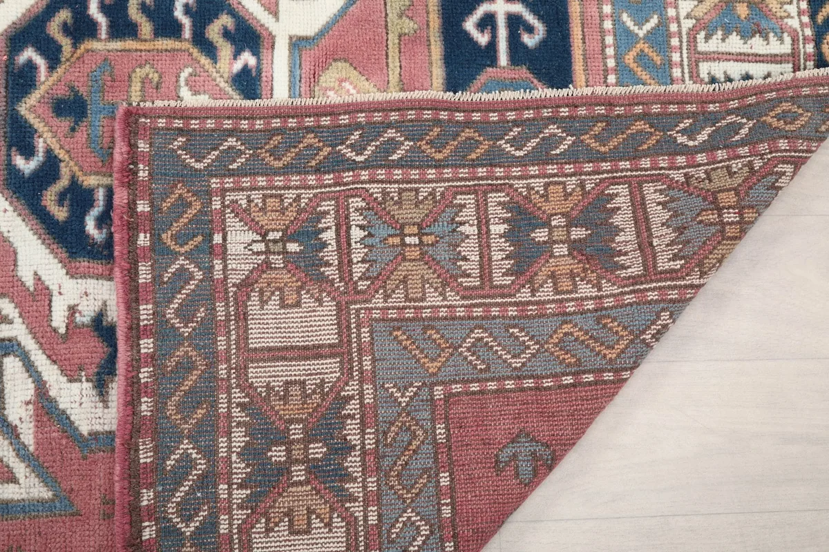 Another folded view of the rug's back, detailing the weave and foundation material