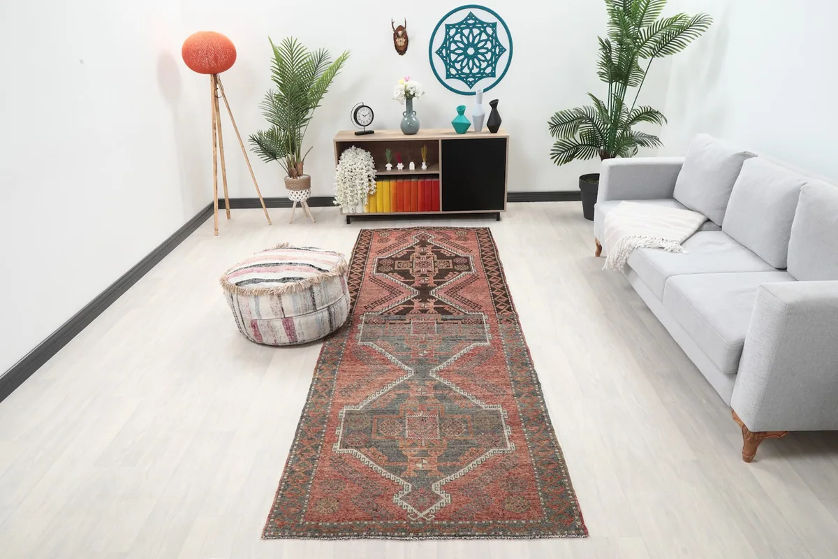 Vintage runner rug in a modern living room setting, showing its length and colors