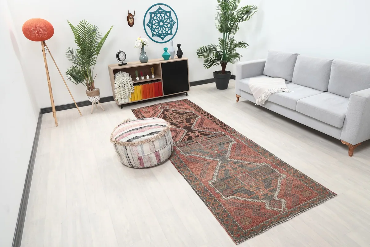 Overhead angle of the runner rug placed in a room with a sofa and ottoman