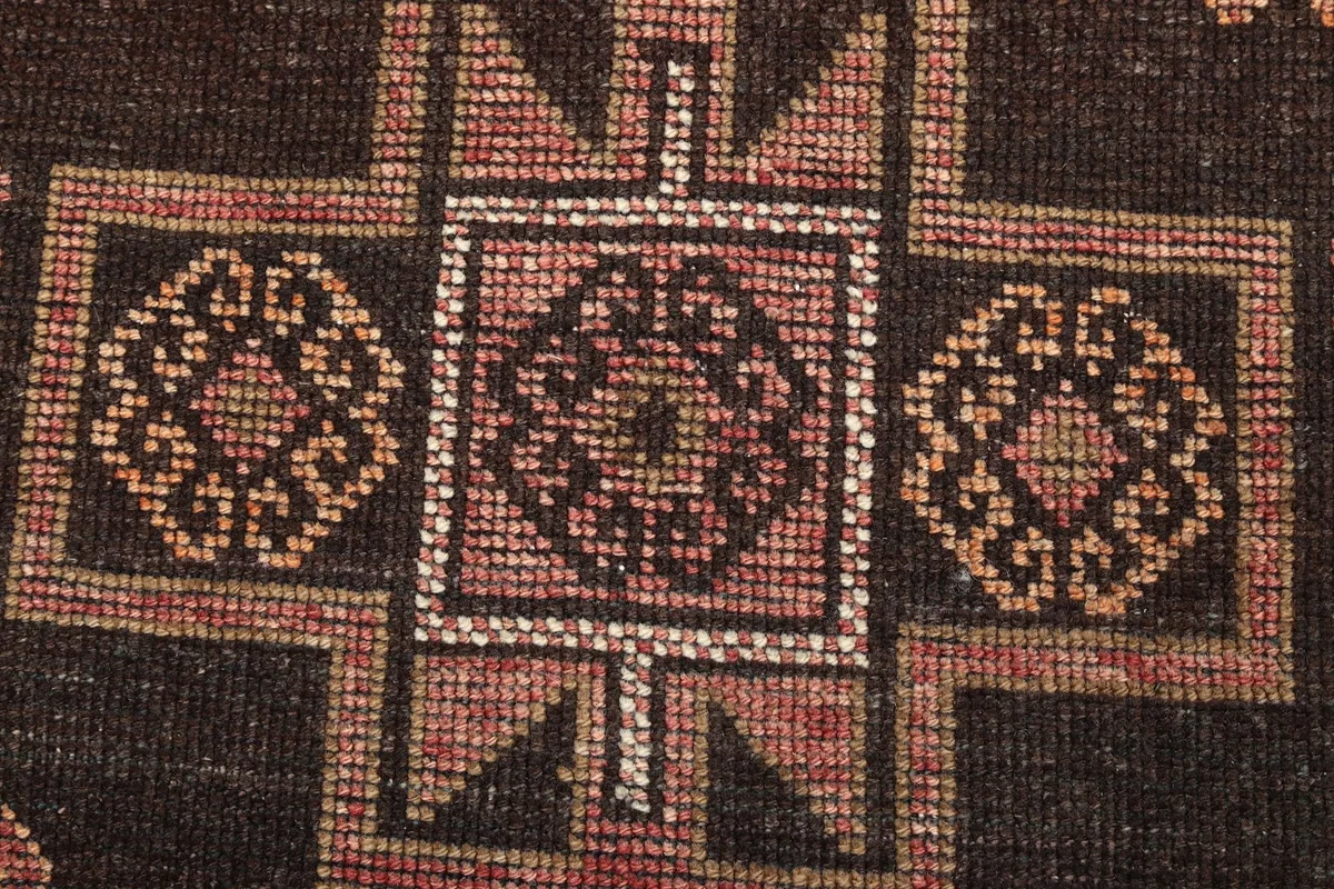 Extreme close-up showing the hand-knotted texture and individual knots of the central medallion