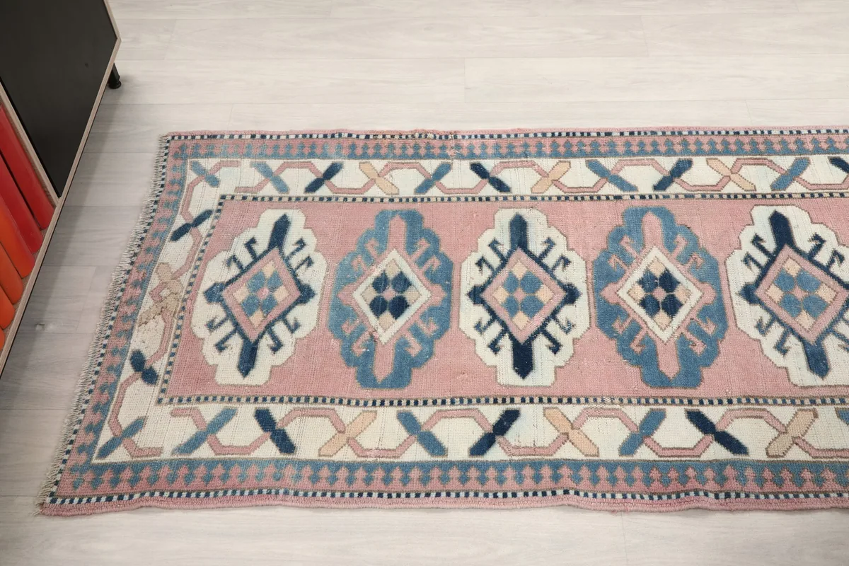 Angled view of the runner's length, showcasing the series of tribal medallions