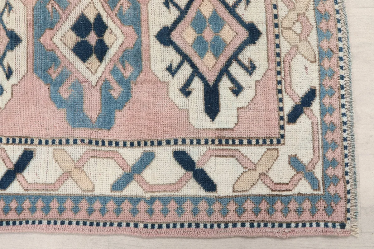 Detailed view of the corner of the runner showing geometric patterns and border