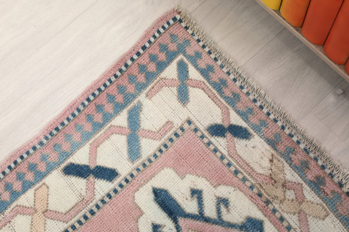 Close-up of the rug's border and corner design, showing subtle color variations