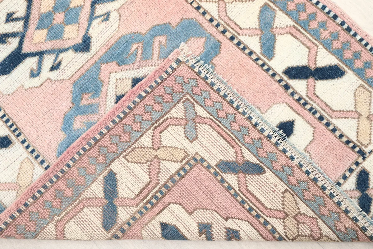 Close-up of the rug's pile and weave structure, showing its vintage texture