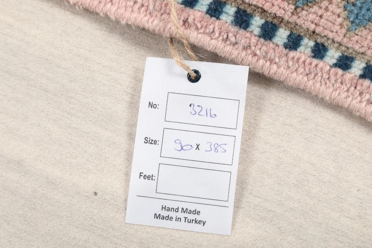 Product tag indicating the rug's size in cm and origin as hand-made in Turkey