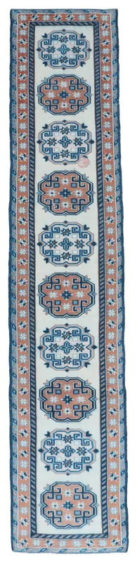 Full overhead view of the 2'4" x 11'11" vintage Anatolian runner rug on a white background