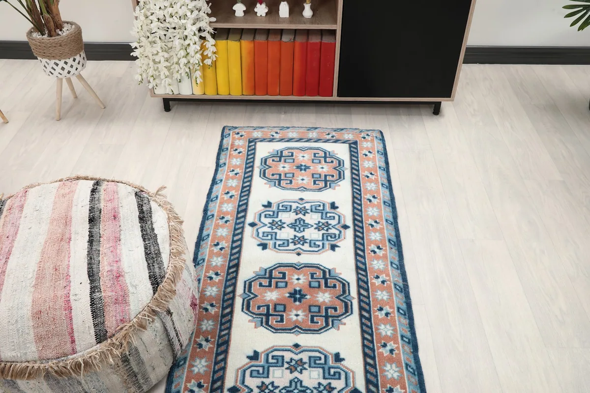 Overhead view of the runner rug in a room, highlighting its length and repeating geometric pattern