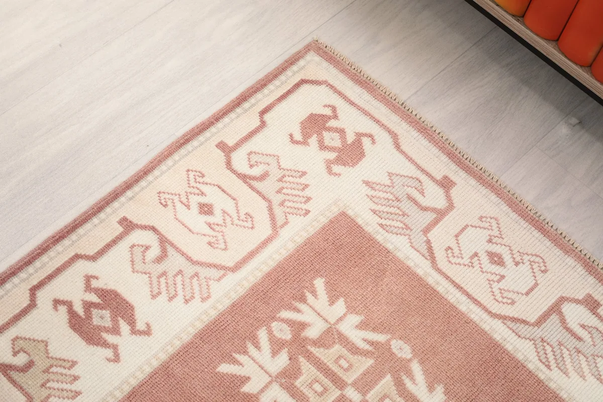 Detail of the runner's border design, highlighting the ivory and rose patterns