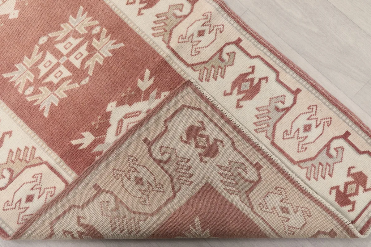 View of the back of the hand-knotted runner, showing a corner folded over