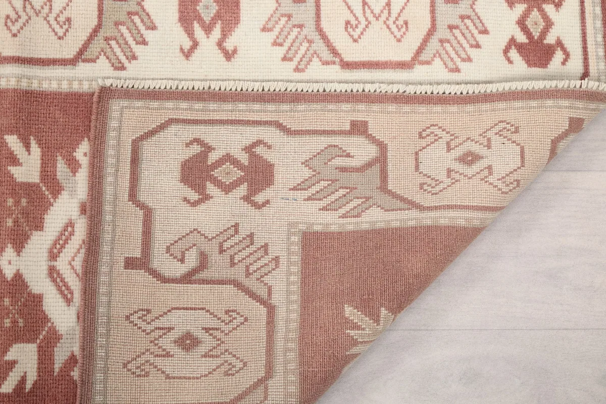 Close-up of the back of the runner rug, revealing the intricate hand-knotting and foundation