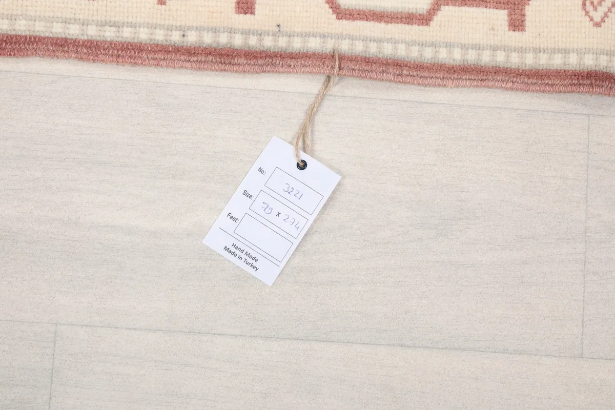 Product tag attached to the runner rug, displaying size information and origin
