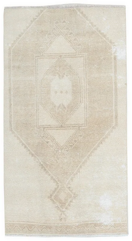 Full top view of the 2'10" x 4'5" vintage Anatolian area rug with a beige and tan geometric medallion.