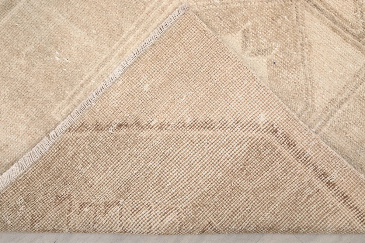 View of the back of the rug, revealing the cotton foundation and hand-knotted structure.