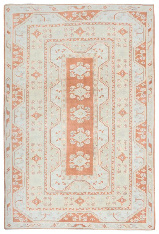 Full top view of the 6'11" x 8'10" rust and ivory geometric Anatolian rug