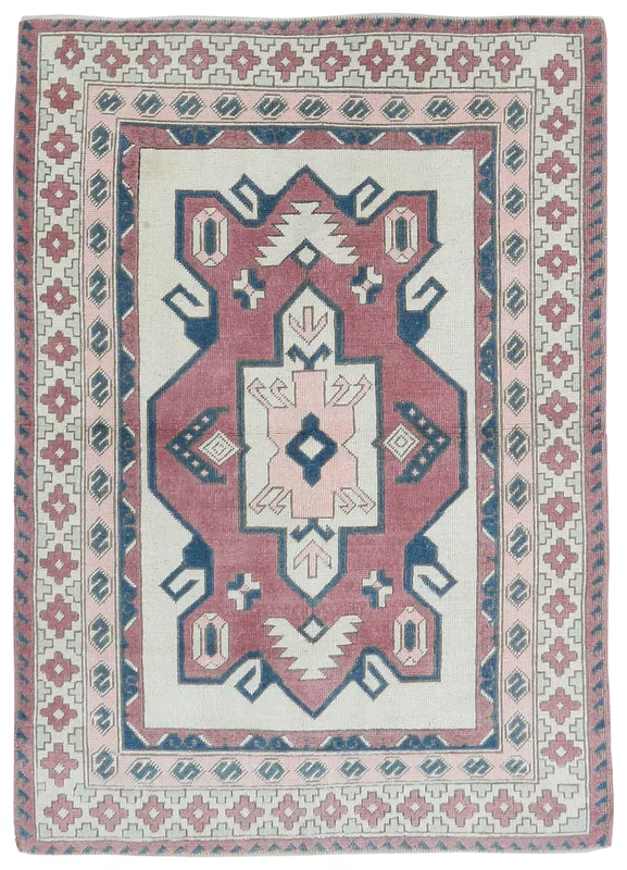 Full top view of the 4x6 vintage Anatolian rug with rose, navy, and ivory geometric patterns
