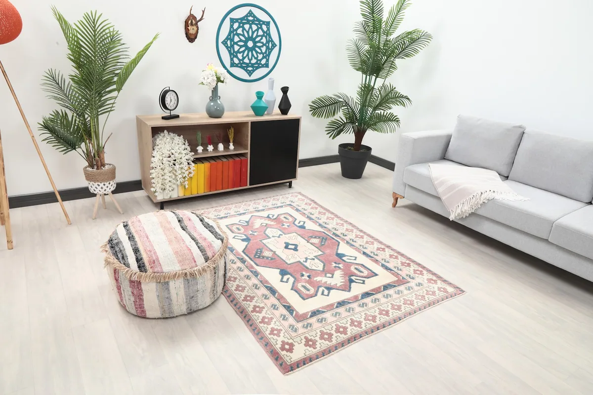 Overhead view of the small Anatolian rug in a room, showing its geometric design