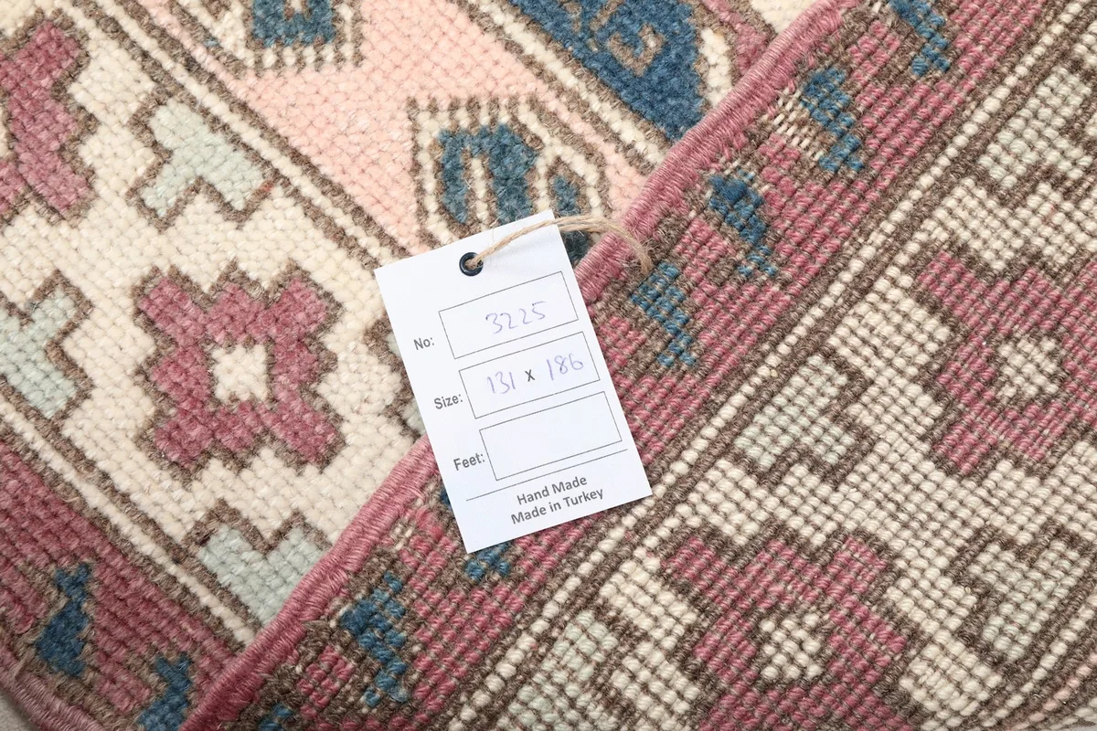 Product tag showing 'Hand Made in Turkey' and size '131 x 186 cm' attached to the rug