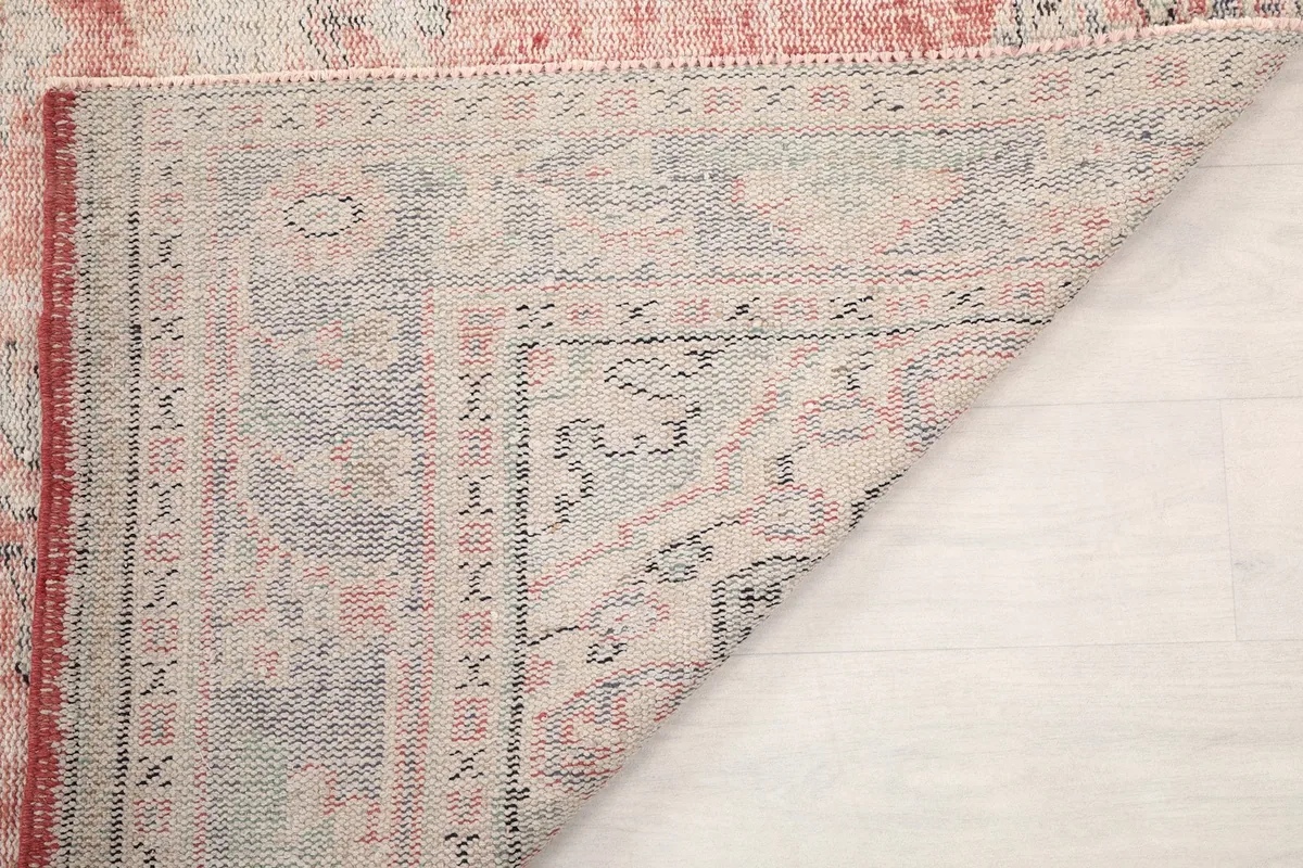 Close-up of the rug's backside, showing the hand-knotted wool on cotton foundation