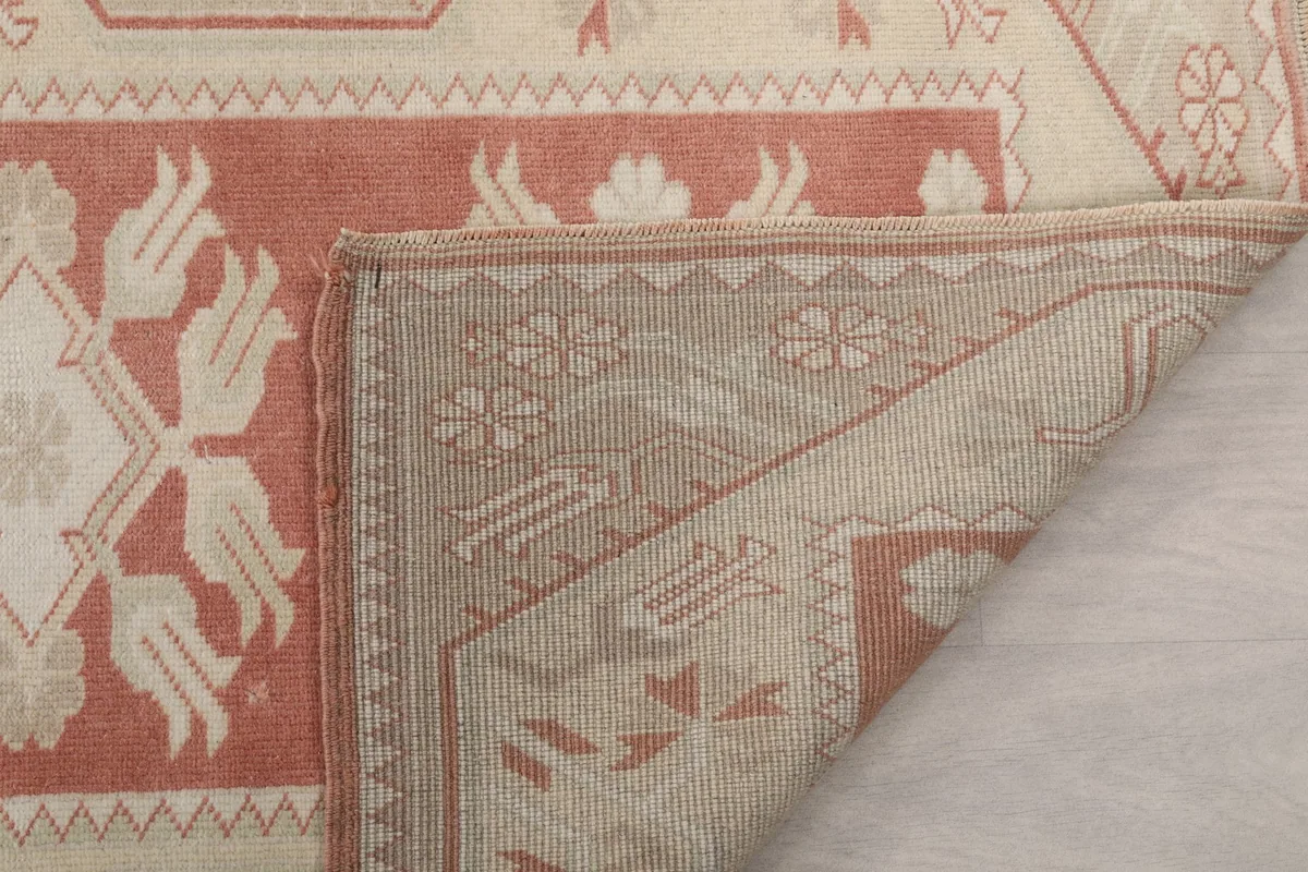 Detail of the rug's reverse side, showing the tight hand-knotting and material structure.