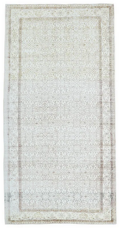 Full overhead view of the 6'2" x 10'5" ivory and brown vintage Anatolian area rug