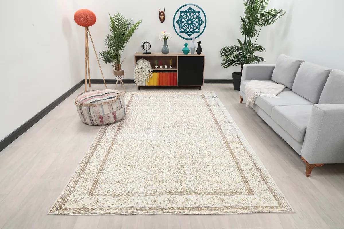 Vintage Anatolian rug in an open living space with light-colored walls and modern furniture