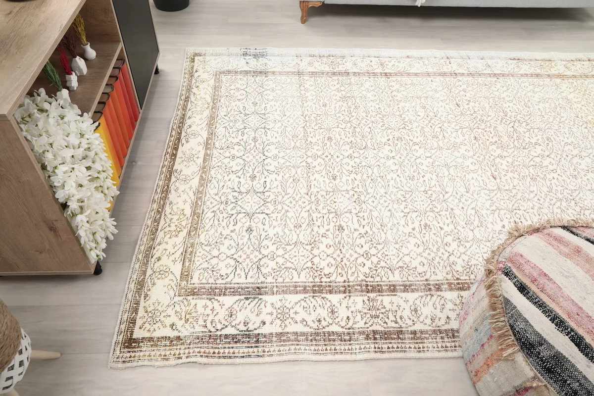 Overview of the rug's placement in a room, demonstrating its large size and light tones