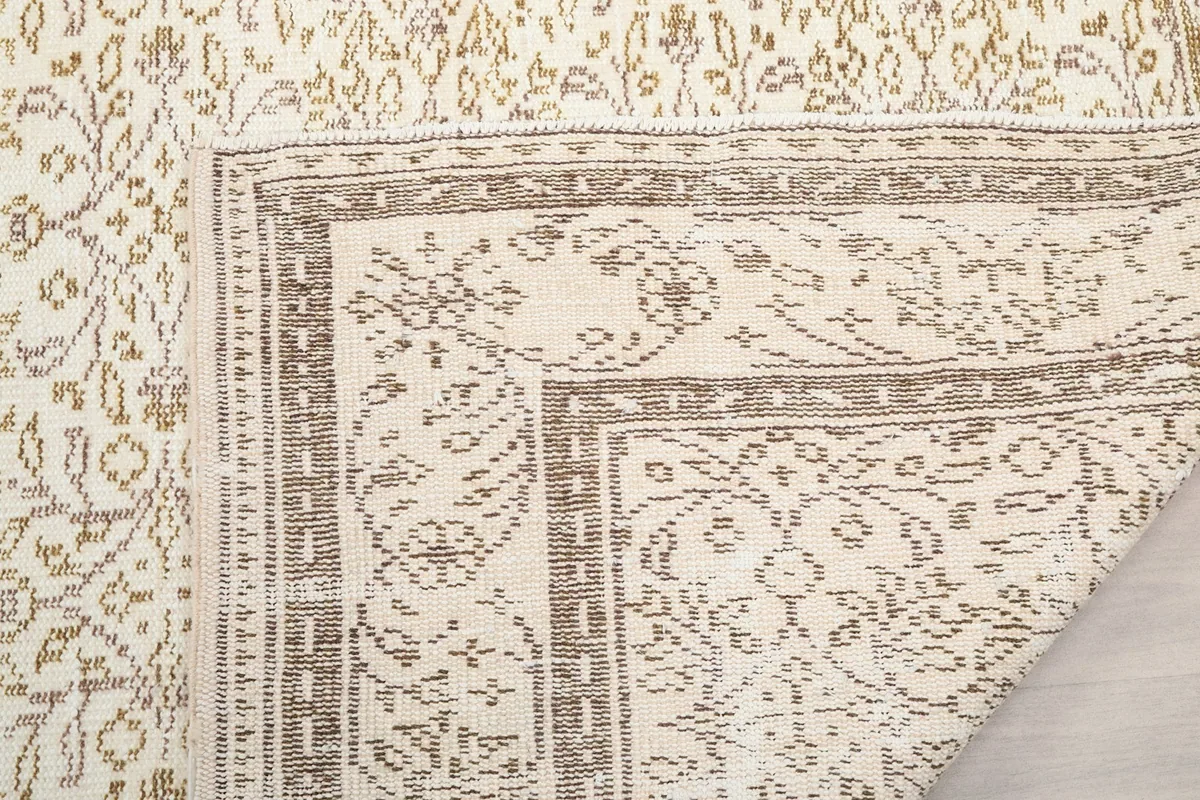 Close-up of the rug's back, showing the knotting and the structure of the vintage piece