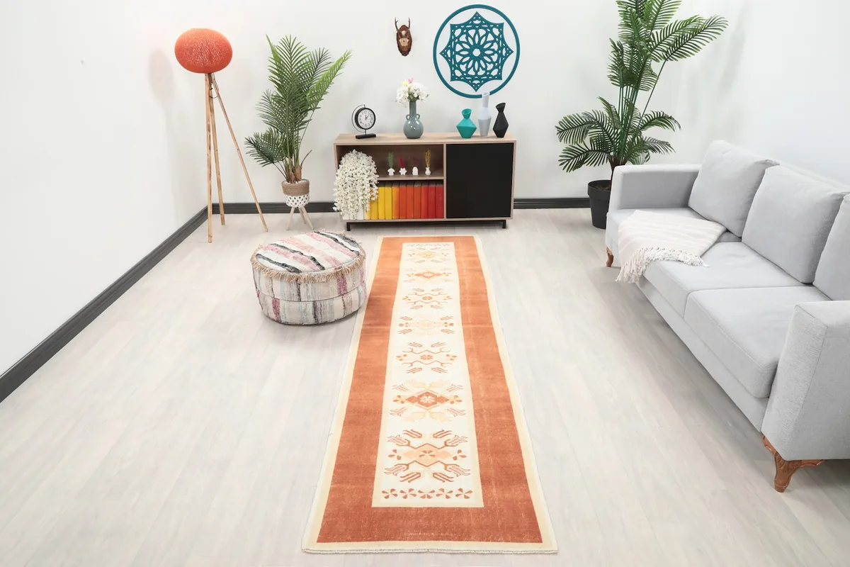 Vintage rust and ivory runner rug displayed in a modern living room setting