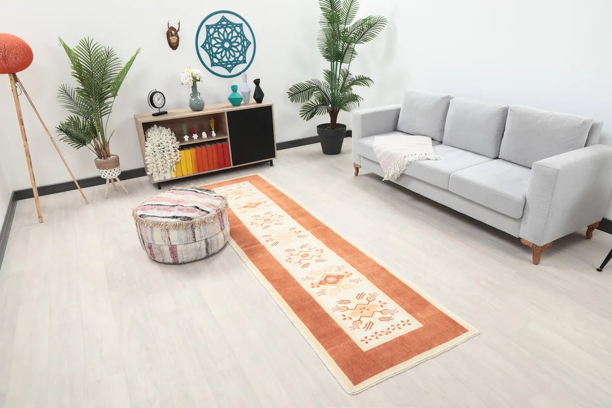 Overhead view of the hand-knotted runner rug in a room, showing its full length
