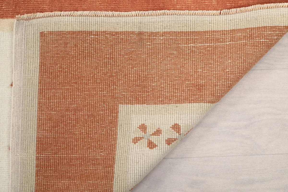Underside of the rug, revealing the hand-knotted cotton foundation