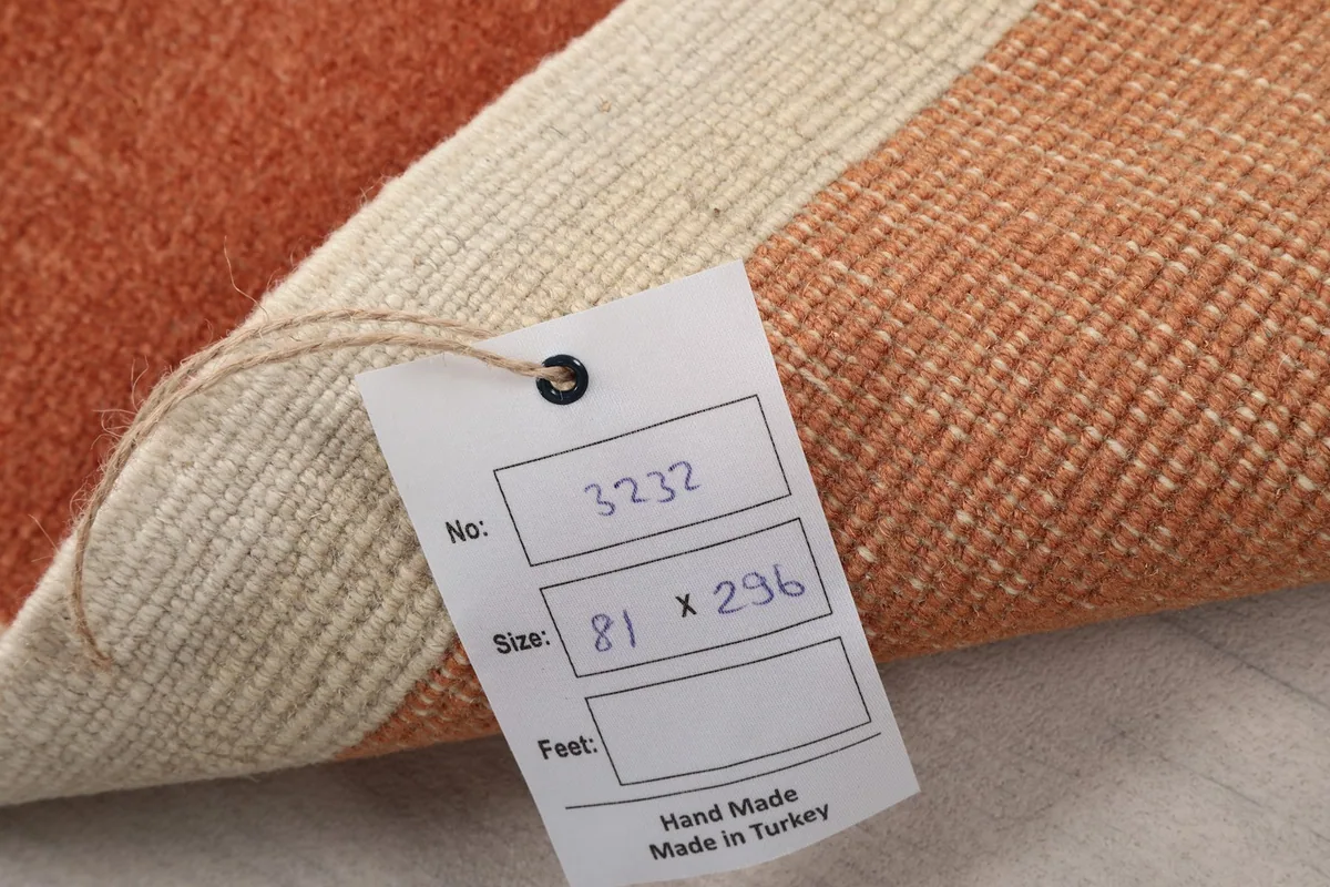 Tag showing the rug's dimensions in cm and confirming its hand-made origin in Turkey